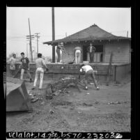 High school students cleaning up abandoned Southern Pacific railroad station in Watts, Calif., 1966