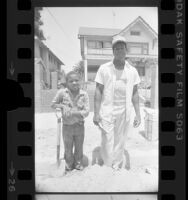 Bricklayer Steve Conners with his young brother Malborn Shaw in Los Angeles, Calif., 1984