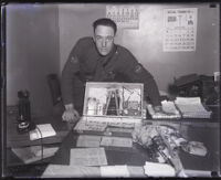 Traffic officer R. W. Olson with a briefcase bomb used in an attempted bank robbery, Los Angeles, 1931