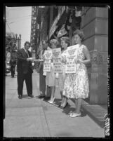 Four Jehovah's Witnesses members handing out literature in Los Angeles, Calif., 1960