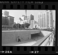 Homeless woman walking from underground garage at Pershing Square in Los Angeles, Calif., 1981