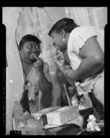 Actress Hattie McDaniel at her dressing table mirror, 1940