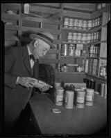 Gardener Henry O'Melveny with containers of seeds, Los Angeles, 1936