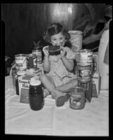 Little girl with donated goods at the Los Angeles Orphans' Home Society, Los Angeles, 1935