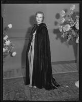 Actress Louise Brien models a long cape at a Times' fashion show, Los Angeles, 1935