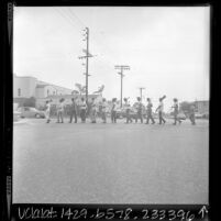 Community Conservation Corps members with shovels marching along Central Ave. in Los Angeles, Calif., 1966