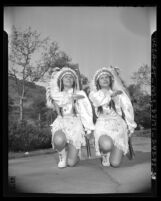 Chippewa twins giving salute that ends rifle drill at Indian Day Festival in Los Angeles, Calif., 1943