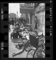 Demonstrators laying on sidewalk outside President Richard Nixon's Los Angeles campaign headquarters, 1972