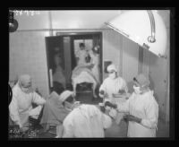 Student nurses and interns in an operating room, Queen of Angels Hospital, Los Angeles, 1956