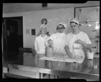 Women kitchen staff working in the Los Angeles General Hospital Kitchen