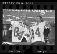 George H. W. Bush and Ronald Reagan with football jerseys presented to them at GOP convention in Dallas, Tex., 1984