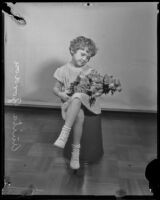 Anita Gordon holding a bouquet of roses, Los Angeles, 1935