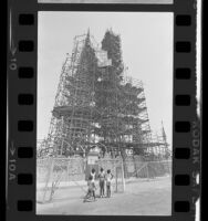 Four girls looking at scaffolding surrounding Watts Towers in Los Angeles, Calif., 1984