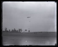 Parachutist Mary Wiggins nearing a ground target above an open field, Los Angeles, 1931
