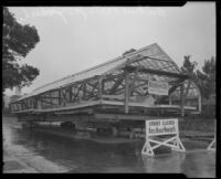 Greenhouse for the estate of Arthur Letts, Jr., as it is transported on a residential street, Los Angeles, circa 1927