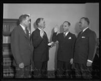 Judge Edward T. Bishop and Joe Crider, Jr. watch as Frank S. Hutton swears in Goodwin Knight, Los Angeles, 1935