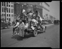 Native Americans ride in a truck down North Spring Street on Labor Day, Los Angeles, 1933