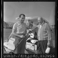 Richard Nixon and Dwight Eisenhower posing next to cart while golfing in Southern California, 1965