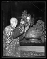 Woo Tong making offering in ceremony at the Chinese Temple of Kuan Kung, Los Angeles, 1935