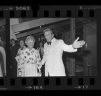 Otis Chandler, Los Angeles Times publisher, greets a guest at wedding reception for son Norman, 1976