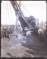 Crowd gathered around a steam shovel as it digs the initial trench for a Chrysler Motor plant, Los Angeles, 1932