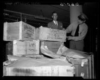 Los Angeles Customs Inspectors looking over boxes of scientific material belonging to California Institute of Technology professor Dr. Hsue-shen Tsien, 1950