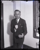 Buron Fitts, standing in his office, Los Angeles, 1920s