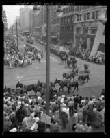 Crowd watching twenty-mule-team wagon from Death Valley parading down Broadway during Centennial event for Los Angeles, Calif., 1950