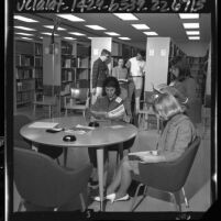 Group of Boy and Girl Scouts reading in Space Technology Laboratories' library in Redondo Beach, Calif., 1964