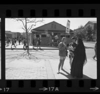 Students picketing UCLA job placement center with placards reading "Make Love Not War" and "No Military Money at UCLA", 1967