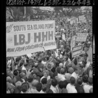 Crowd of people carrying banners during political rally for Lyndon B. Johnson in Los Angeles, Calif., 1964