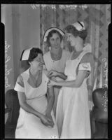 Lorene Convirs pins a sorority pin on Dorothy Paxton while Harriet Womack looks on, Los Angeles, 1935