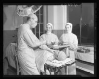 Surgical nurses and identical twins Thelma and Zelma Trammell, Dr. Ralph Milliken, and Ramon Garcia, Wadsworth Hospital, Los Angeles, 1947