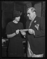 Widow Ivy Focher receives a check from Lou Daro, Los Angeles, 1935