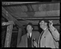 Detective Lieutenants Ray Giese and Dalton R. Patton examine William Spinelli's cellar, Los Angeles, 1938