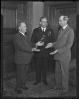 Frank Shaw receives a special birthday cake with Justice Minor Moore and Chief James Davis, Los Angeles, 1936
