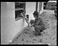 Seven-year-old witness Virginia Carter playing with dog, Los Angeles, 1935