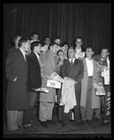 Henry "Red" Sanders surrounded by students after agreeing to remain as UCLA head football coach, 1949