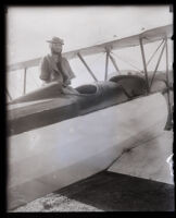 Armless pilot Josephine Callaghan sitting on a biplane at Dycer airport, Los Angeles, 1929