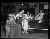 Sailor and young women demonstrating boat mooring, Los Angeles Boat Show, Los Angeles, 1930