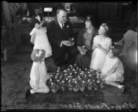 Los Angeles Mayor Frank Shaw with girls, woman, and Easter baskets, [Los Angeles?], 1933-1938