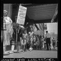 American Indians,in tribal garb, picketing in front of Bureau of Indian Affairs headquarters in Los Angeles, Calif., 1964