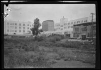 Damaged building seen from across a vacant lot after the Long Beach earthquake, Southern California, 1933