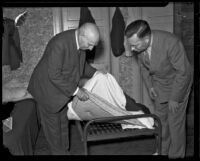 Governor Frank Merriam inspects a bed in a hotel, California, 1934-1939