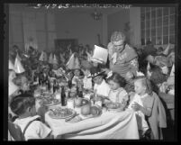 Joe Morse with orphans at Thanksgiving dinner Friar's Club Los Angeles, Calif., 1948