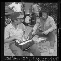 Mexican bracero and Mexican American agricultural laborers eating lunch in Ventura County, Calif., 1964