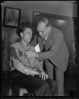 Detective Captain Bert Wallis inspects a blood stain on murder suspect James Fagan Culver, Los Angeles, 1936