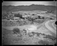 Buildings above the upstream face of the Bouquet Canyon earth-fill dam during dam construction, 1933