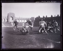 Football mid-play action, blocking U.S.C. vs. Notre Dame at the Coliseum, Los Angeles, circa 1928