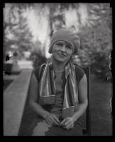 Millicent Sunday seated in a chair in a park or yard, Los Angeles, 1928